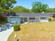 Charming single story home with a well maintained front lawn and an attached two car garage at 1952 Algonquin Dr, Clearwater, FL 33755