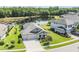 Aerial view of home showcasing lush landscaping, backyard pond, and three-car garage at 19837 Lonesome Pine Dr, Land O Lakes, FL 34638
