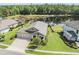 Stunning aerial view of home, fenced yard, and serene lake with verdant surroundings at 19837 Lonesome Pine Dr, Land O Lakes, FL 34638