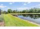 Beautiful backyard with a pond view surrounded by lush greenery and mature trees at 19837 Lonesome Pine Dr, Land O Lakes, FL 34638
