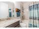 Bathroom featuring a granite countertop vanity, tiled tub-shower, and modern fixtures at 19837 Lonesome Pine Dr, Land O Lakes, FL 34638