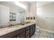Elegant bathroom featuring a double sink vanity with granite counters and modern fixtures at 19837 Lonesome Pine Dr, Land O Lakes, FL 34638