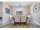 Bright dining room with modern chandelier, a wooden table with upholstered chairs, and large window with a scenic view at 19837 Lonesome Pine Dr, Land O Lakes, FL 34638
