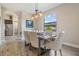 Bright dining room with modern chandelier, a wooden table with upholstered chairs, and large window with a scenic view at 19837 Lonesome Pine Dr, Land O Lakes, FL 34638