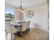 Bright dining room with modern chandelier, a wooden table with upholstered chairs, and large window with a scenic view at 19837 Lonesome Pine Dr, Land O Lakes, FL 34638