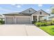 Charming single-Gathering home with a well-manicured front yard and attached two car garage at 19837 Lonesome Pine Dr, Land O Lakes, FL 34638