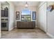 Bright hallway with a wooden console table, modern art and a window view with laundry room access at 19837 Lonesome Pine Dr, Land O Lakes, FL 34638