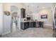 Modern kitchen featuring dark wood cabinetry, stainless steel appliances, and granite countertops with an open floorplan at 19837 Lonesome Pine Dr, Land O Lakes, FL 34638