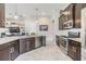Modern kitchen featuring dark wood cabinetry, stainless steel appliances, and granite countertops with recessed lighting at 19837 Lonesome Pine Dr, Land O Lakes, FL 34638