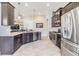 Modern kitchen featuring dark wood cabinetry, stainless steel appliances, and granite countertops with recessed lighting at 19837 Lonesome Pine Dr, Land O Lakes, FL 34638