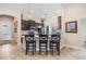 Modern kitchen featuring dark wood cabinetry, stainless steel appliances, and granite countertops with barstool seating at 19837 Lonesome Pine Dr, Land O Lakes, FL 34638
