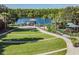 Community lakeside park featuring a dock, pavilion, playground, and landscaped amphitheater at 19837 Lonesome Pine Dr, Land O Lakes, FL 34638