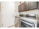 Well-equipped laundry room with modern appliances, and overhead cabinet storage at 19837 Lonesome Pine Dr, Land O Lakes, FL 34638