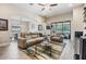 Open-concept living room featuring stylish furniture, tile floors, and a view of the pool area at 19837 Lonesome Pine Dr, Land O Lakes, FL 34638