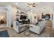 Stylish living room with tile floors, comfortable seating, and an open layout leading to the kitchen at 19837 Lonesome Pine Dr, Land O Lakes, FL 34638