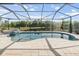 Sparkling screened pool with a view of the lake at 19837 Lonesome Pine Dr, Land O Lakes, FL 34638