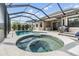 Screened in pool and hot tub with a view of the outdoor living space at 19837 Lonesome Pine Dr, Land O Lakes, FL 34638