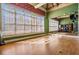 Bright studio space with mirrors, wood floor, fitness equipment, and wall of windows at 19837 Lonesome Pine Dr, Land O Lakes, FL 34638