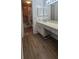 This bathroom features plank flooring, a single sink vanity, and a shower/tub at 200 Country Club Dr # 906, Largo, FL 33771