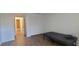 Bedroom featuring wood floors, a window and a walk in closet at 200 Country Club Dr # 906, Largo, FL 33771