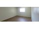 This bedroom is bright and has wood plank flooring and a window at 200 Country Club Dr # 906, Largo, FL 33771