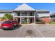 Charming two-story condo building with gray siding, brick accents, and convenient parking available at 200 Country Club Dr # 906, Largo, FL 33771