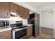 Efficient kitchen featuring stainless steel appliances, range hood and plenty of countertop space at 200 Country Club Dr # 906, Largo, FL 33771