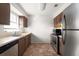 Functional kitchen showcasing stainless steel appliances, wooden cabinets and convenient layout at 200 Country Club Dr # 906, Largo, FL 33771