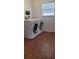 Bright laundry room featuring new washer and dryer and wood floors at 200 Country Club Dr # 906, Largo, FL 33771