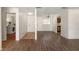 Living room featuring wood floors, an entry door and view of the kitchen at 200 Country Club Dr # 906, Largo, FL 33771
