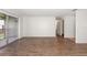 Open living space with wood floors and sliding glass doors to balcony at 200 Country Club Dr # 906, Largo, FL 33771
