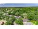 Aerial view of the home surrounded by mature trees in a residential neighborhood at 2010 Rutherford Dr, Dover, FL 33527