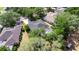 Aerial view of property with mature trees and landscaping surrounded by neighboring homes at 2010 Rutherford Dr, Dover, FL 33527