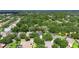Aerial view of property in a neighborhood surrounded by mature trees and landscaping at 2010 Rutherford Dr, Dover, FL 33527