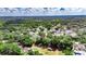 Aerial view of property in a neighborhood surrounded by mature trees and landscaping at 2010 Rutherford Dr, Dover, FL 33527