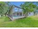 A beautiful lawn view shows the screened pool and home at 2010 Rutherford Dr, Dover, FL 33527
