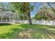 Backyard view of the screened-in pool and white privacy fence at 2010 Rutherford Dr, Dover, FL 33527