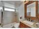 Well-lit bathroom with a tiled shower, granite counter, and ample space at 2010 Rutherford Dr, Dover, FL 33527