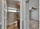 Well-lit bathroom with a tiled shower, granite counter, and ample space at 2010 Rutherford Dr, Dover, FL 33527