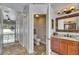 Bathroom view showing a granite countertop, wooden cabinets, and a separate toilet room at 2010 Rutherford Dr, Dover, FL 33527