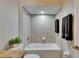 Tiled bathtub/shower combo with modern fixtures and neutral tones, next to granite counter bathroom at 2010 Rutherford Dr, Dover, FL 33527