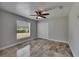 Bright bedroom featuring a ceiling fan, a window with blinds, and closet with bi-fold doors at 2010 Rutherford Dr, Dover, FL 33527