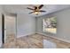 Bedroom with tile flooring, ceiling fan, window overlooking the backyard, and neutral paint at 2010 Rutherford Dr, Dover, FL 33527