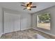 Bedroom with tile flooring, large closet, ceiling fan, and a window letting in natural light at 2010 Rutherford Dr, Dover, FL 33527