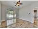 Bright bedroom featuring tiled flooring, ceiling fan, and access to the outdoor pool area at 2010 Rutherford Dr, Dover, FL 33527