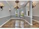 Dining room with travertine tile, chandelier, and large windows bringing in natural light at 2010 Rutherford Dr, Dover, FL 33527