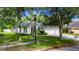 Charming home featuring a well-manicured lawn, mature landscaping, and a spacious three-car garage at 2010 Rutherford Dr, Dover, FL 33527