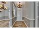 Inviting foyer with chandelier, gray walls, and decorative archway looking into the dining area at 2010 Rutherford Dr, Dover, FL 33527