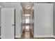Hallway with tiled floor and view of a seating area by the window at 2010 Rutherford Dr, Dover, FL 33527