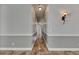 Hallway featuring marble floors, neutral paint, chair railing, and decorative sconces at 2010 Rutherford Dr, Dover, FL 33527